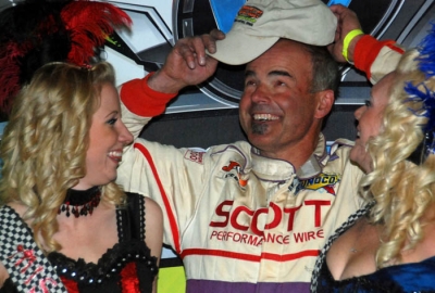 Billy Moyer puts on a cap in victory lane. (DirtonDirt.com)