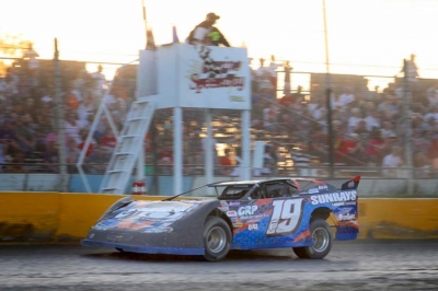 Marshall Fegers takes the checkers at Casino Speedway. (crpphotos.com)