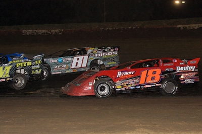 Shannon Babb (18) moved by Scott James (81)in traffic to win at Peoria. (stlracingphotos.com)