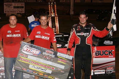 Brad Neat along with crew members Mark Hopper (left) and Whitney McQueary (center) visit victory lane. (Hilary Ballard)