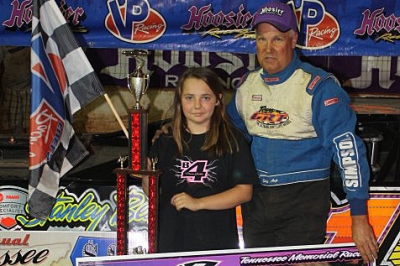 Haley Brooks, who has a rare form of cancer, posed with Skip Arp in victory lane. (Ronnie Barnett)