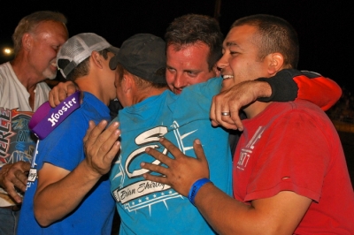 Brian Shirley shares a celebratory group hug with his crew in victory lane. (DirtonDirt.com)