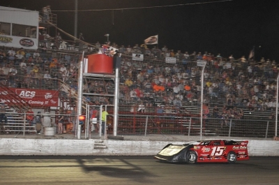Jesse Stovall takes the checkers at Adams County in David Turner's car. (fasttrackphotos.net)