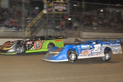 Winner Josh Richards (1) goes by Scott Bloomquist (0) early in the main event. (stlracingphotos.com)