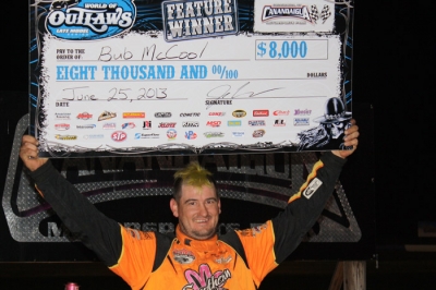 Bub McCool shows off his winner's check at Canandaigua. (Kevin Kovac)