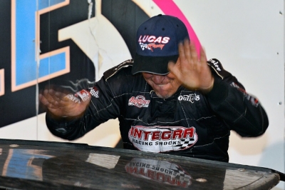 Darrell Lanigan pounds his car's roof in victory lane. (thesportswire.net)
