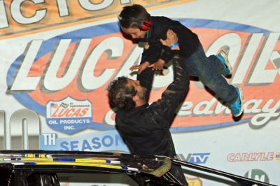 Justin Russell lifts his son Blaine in victory lane. (cbracephotos.com)