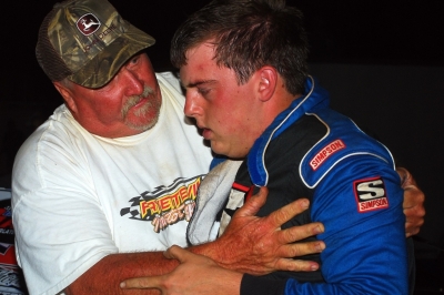 Billy McFayden checks on winner Dustin Mitchell (right) after he was sucker-punched by a fan in victory lane. (focusedonracing.com)