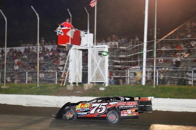 Terry Phillips takes the checkers at I-80 Speedway. (fasttrackphotos.net)
