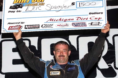 Eric Spangler shows off the winner's paycheck after his Merritt Raceway victory. (Jim DenHamer)