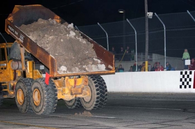 The first load of dirt is dumped onto the Berlin asphalt. (Steve Datema)