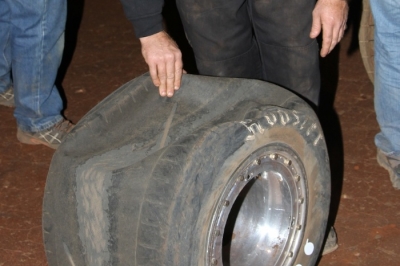 A crew member looks at Marlar's tire after the race. (Clifford Dove)