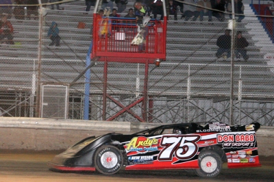 Terry Phillips takes the checkers Friday at Tucson International Raceway. (photosbyshana.net)