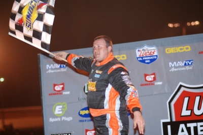 Eddie Carrier Jr. celebrates atop his car. (DirtonDirt.com)