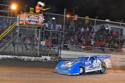 Kyle Bronson takes the white flag in his upset victory at Volusia. (thesportswire.net)