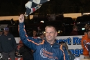 Mike Marlar waves the checkered flag in victory lane at Ponderosa Speedway after winning Saturday's Big Daddy Classic. The race, part of the 32nd annual Fall Classic weekend was sanctioned by the Valvoline Iron-Man Series and paid $10,088. (Ryan Roberts)
