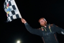 Joseph Joiner waves the checkers March 31 at Buckshot Speedway in Clanton, Ala., after his first career Schaeffer&#039;s Spring Nationals victory. (Zackary Washington/Simple Moments Photography)