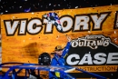 Mike Marlar unfurls the checkers to signal Sept. 29&#039;s $10,000 victory with the World of Outlaws Case Late Model Series at Atomic Speedway in Alma, Ohio. (jacynorgaardphotography.com)