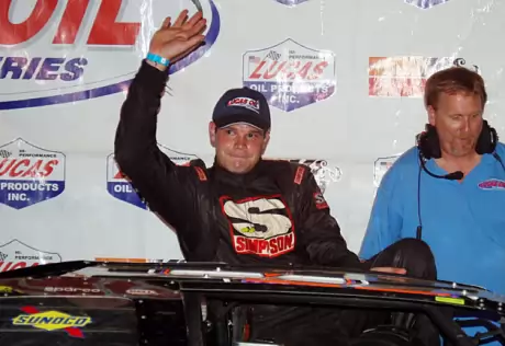 Brad Neat climbs out in victory lane. (Robert Holman)