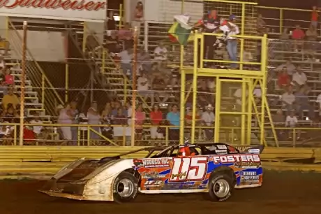 Brandon Smith takes the checkers at 67 Speedway. (Woody Hampton)