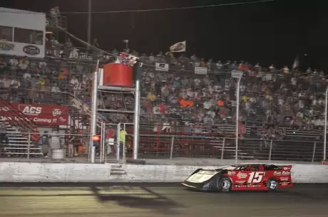 Jesse Stovall takes the checkers at Adams County in David Turner's car. (fasttrackphotos.net)