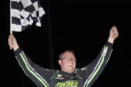 Jason Feger celebrates his $10,000 victory. (Jim DenHamer)